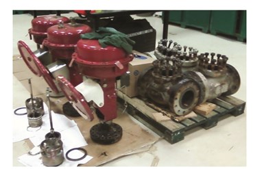 Oil field valves undergo servicing and inspection in the shop.